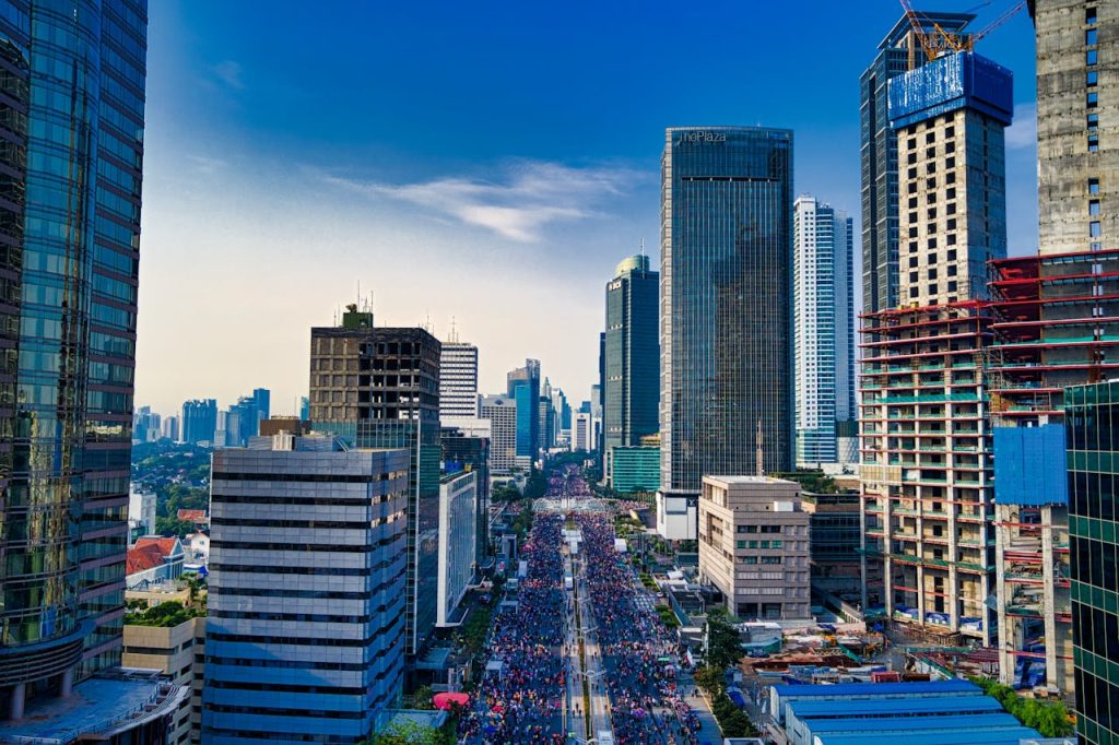 Stunning aerial view of Jakartas modern skyline with bustling streets below.
